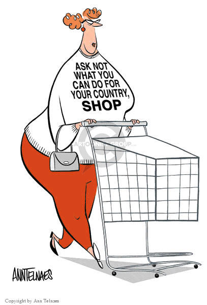 (No caption.)  A woman pushing a shopping cart wears a t-shirt that is imprinted with "Ask Not What You Can Do For Your Country, Shop".